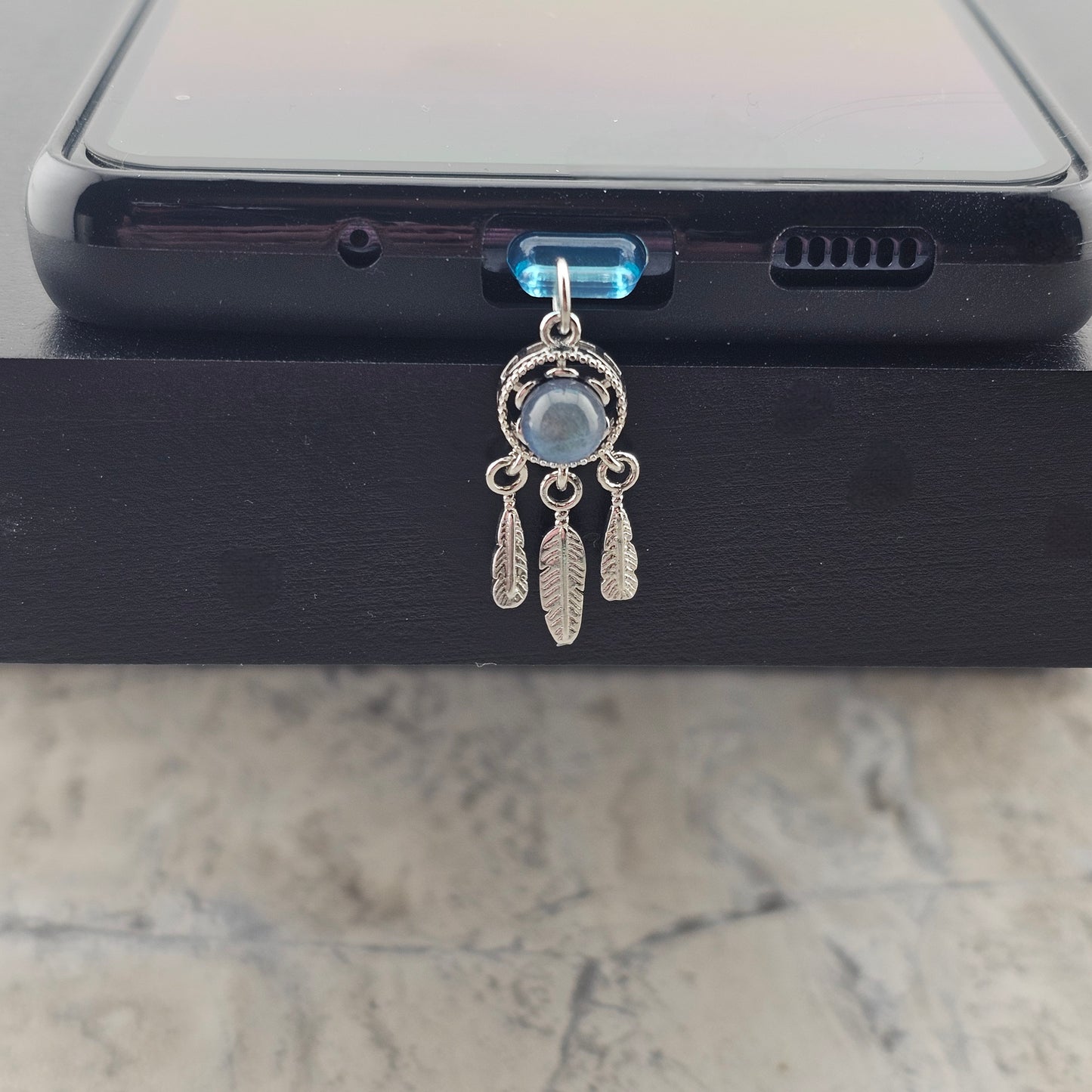 Shows how a version of a charm will look on the phone case