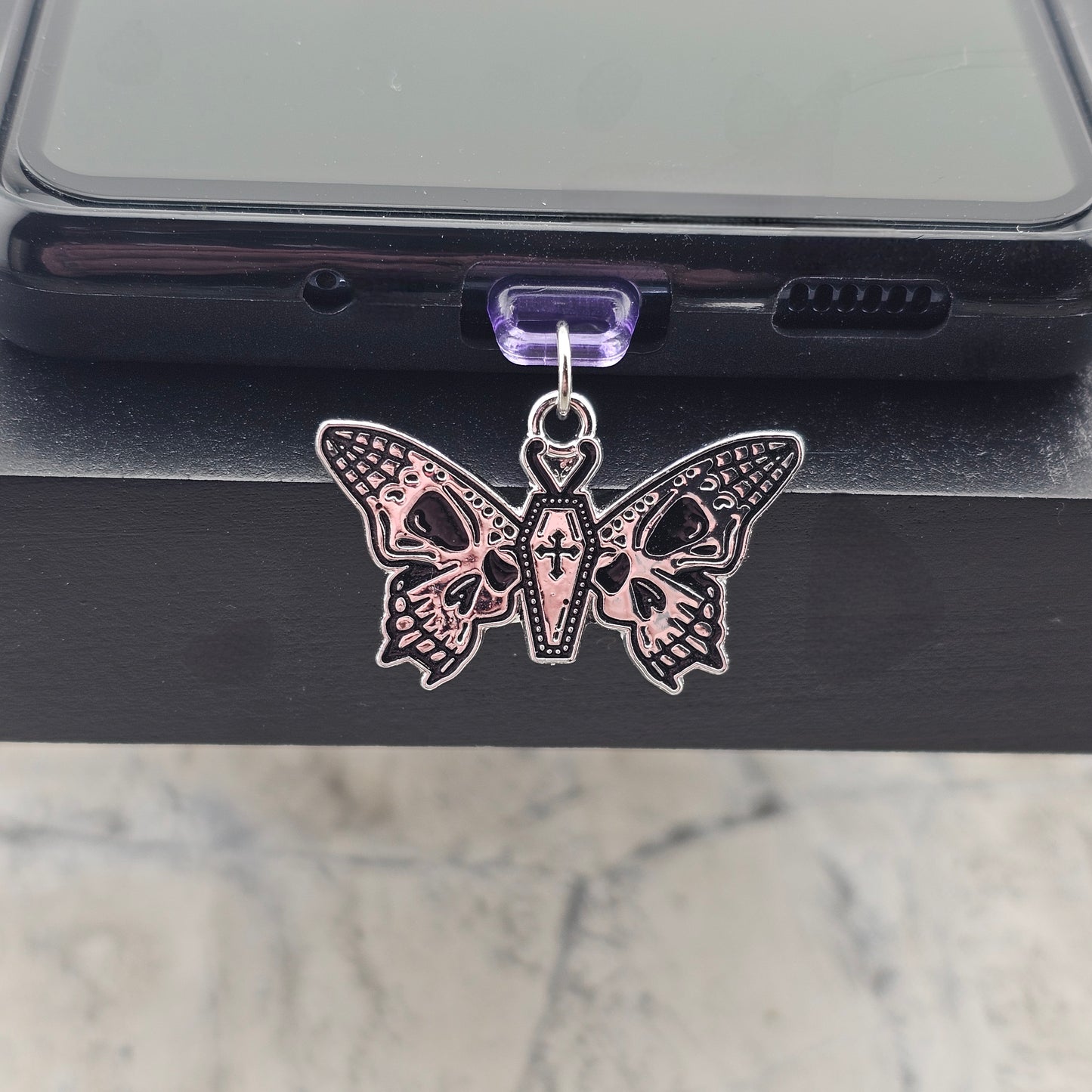 Shows how a version of a charm will look on the phone case