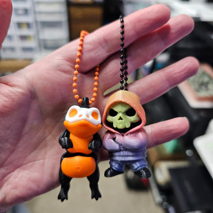 Hand holding a small toy figure with a colorful design, blurred background