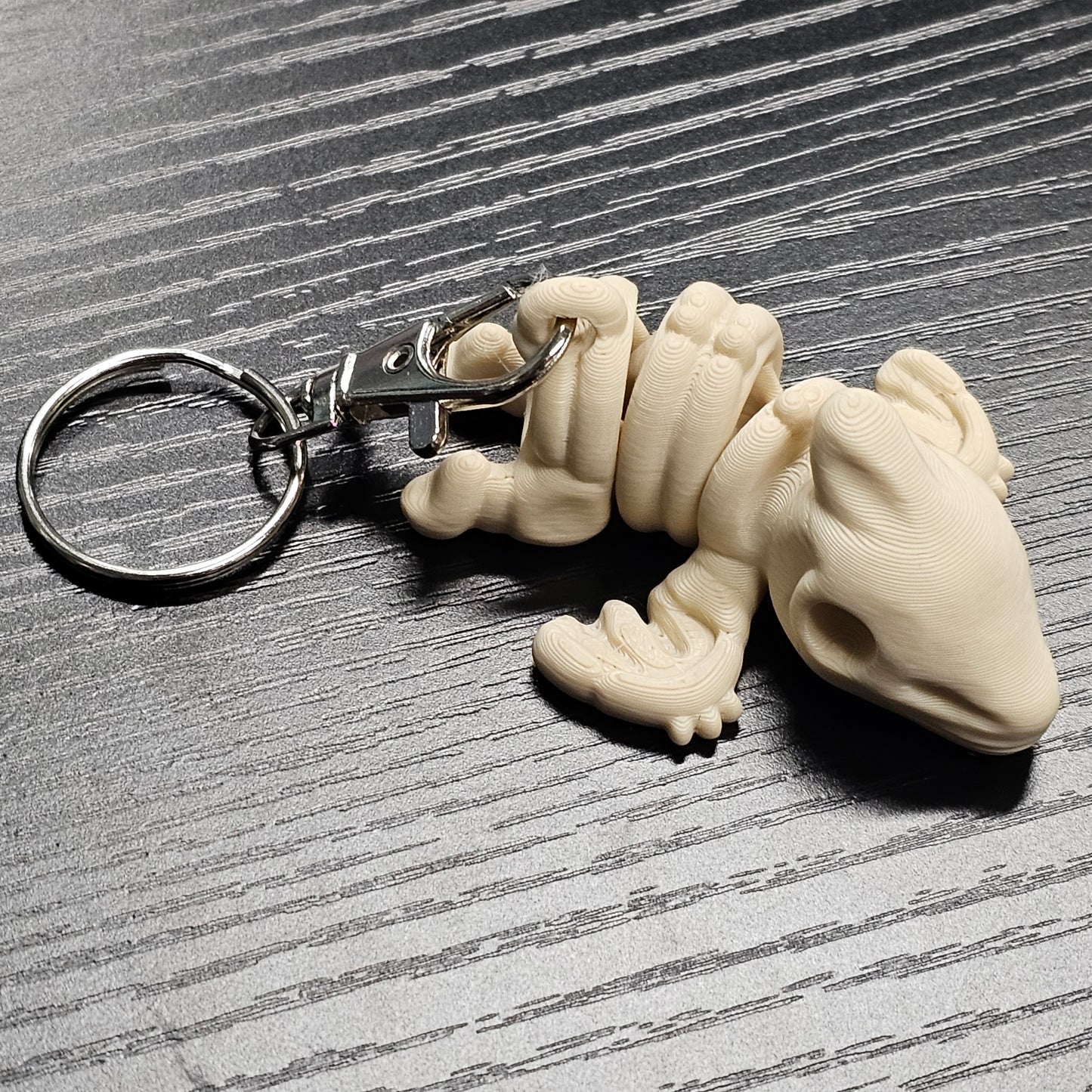 Keychain of a bone shaped dinosaur