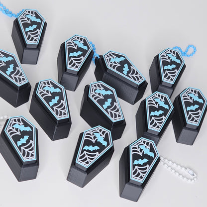 photo of coffin clicker keychains laid out