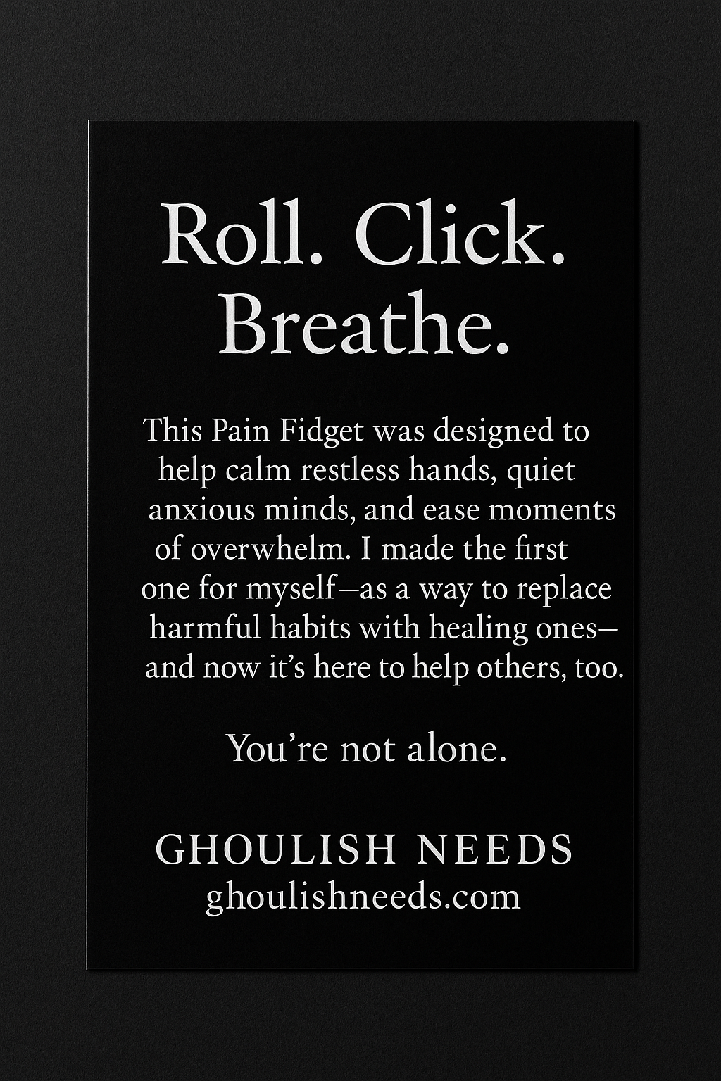 Black background with white text about a pain fidget product by Ghoulish Needs.