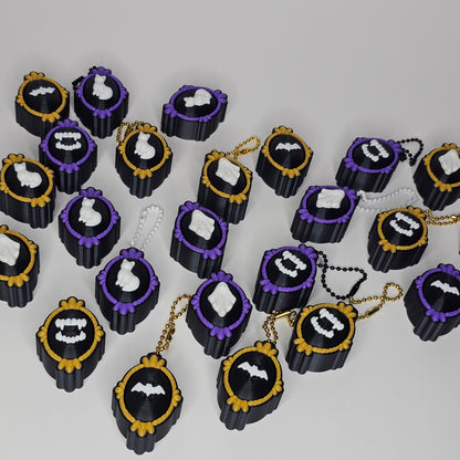 Purple and gold framed keychain clickers