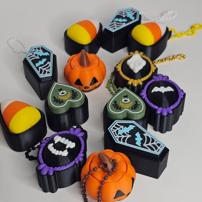 Halloween-themed keychains and charms on a white background